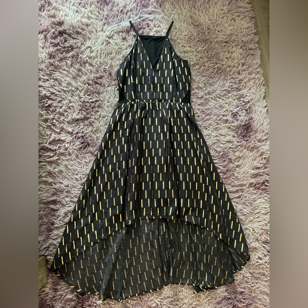 Black and gold evening dress. Spaghetti straps. Knee length.